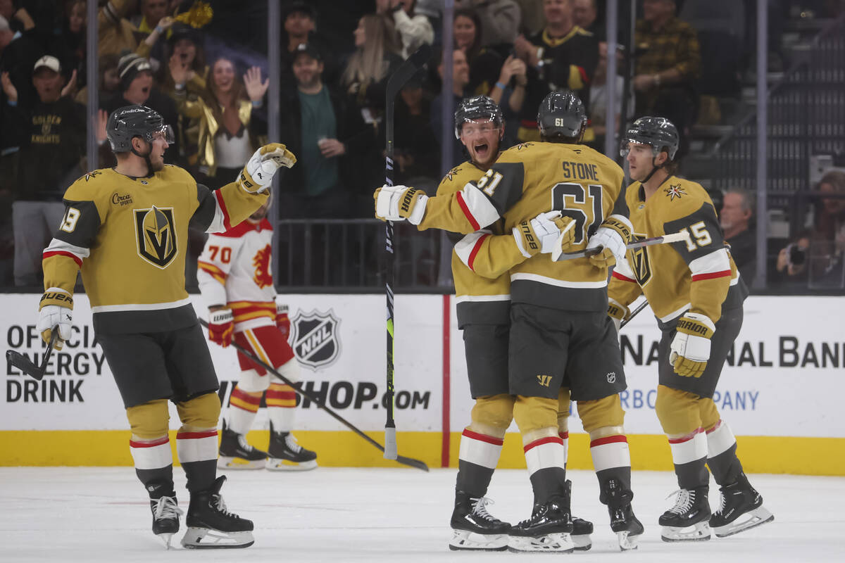 Golden Knights right wing Mark Stone (61) celebrates his goal with Golden Knights center Jack E ...