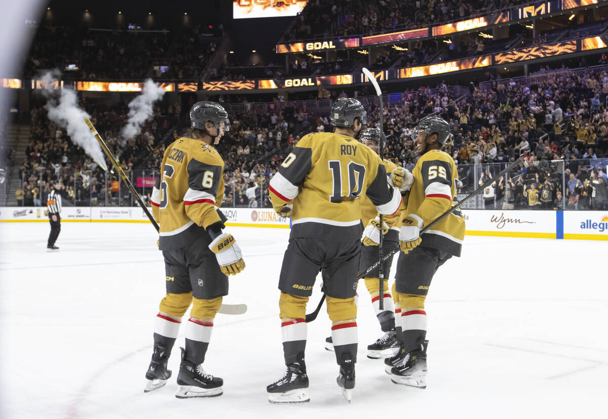 The Golden Knights celebrate after scoring against the Calgary Flames during the third period o ...