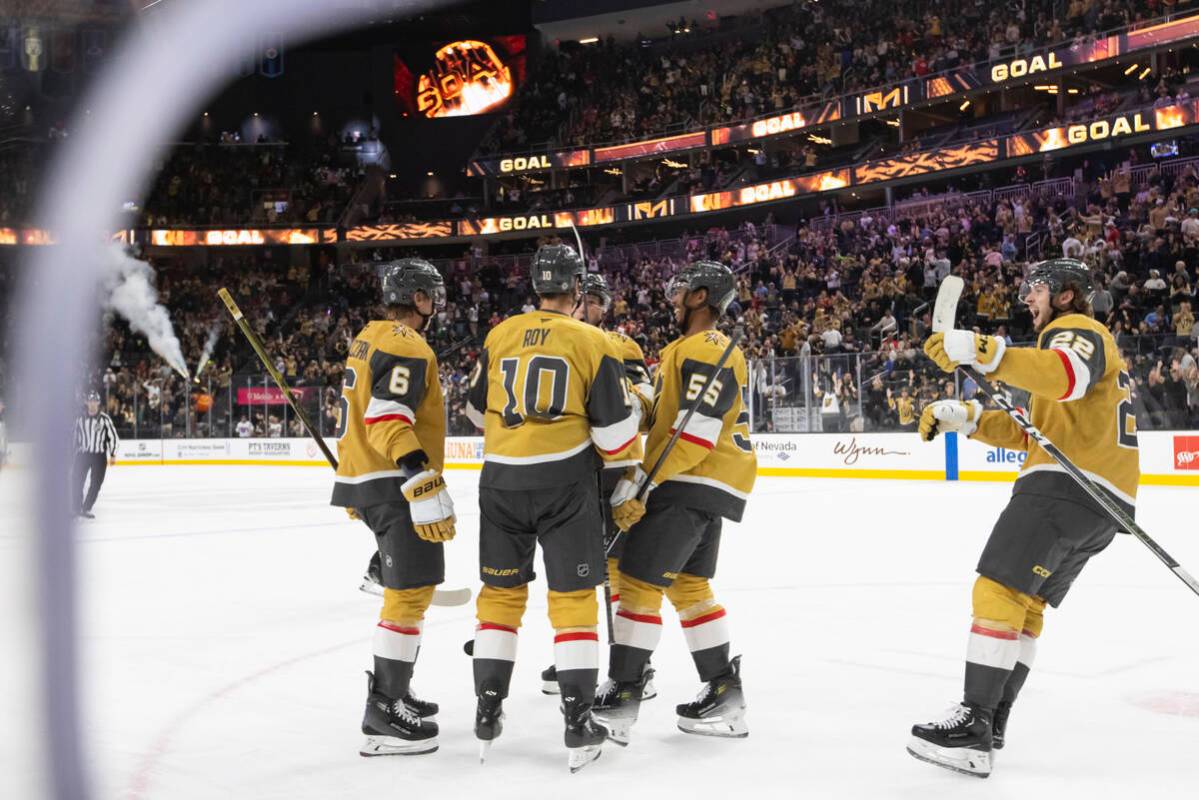 The Golden Knights celebrate after scoring against the Calgary Flames during the third period o ...