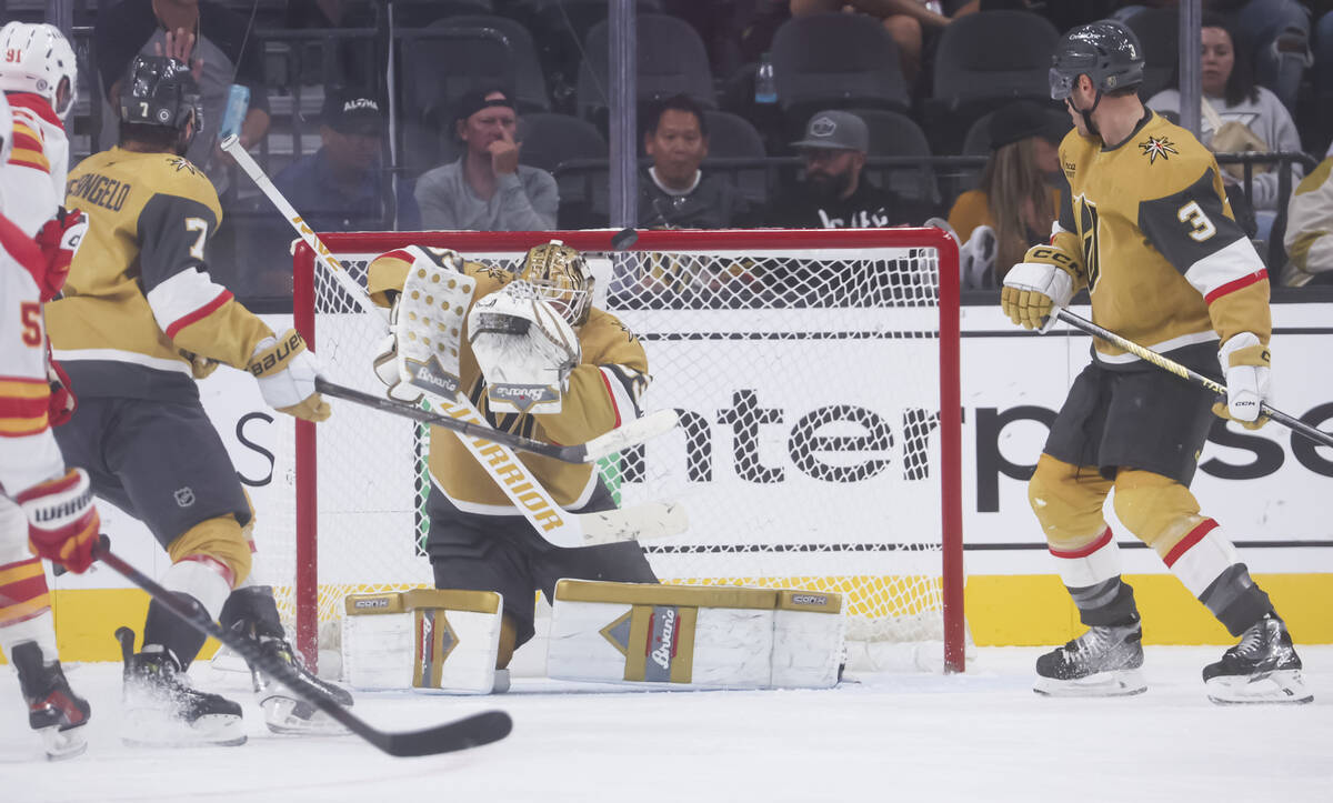 Golden Knights goaltender Adin Hill (33) blocks a shot from the Calgary Flames during the third ...