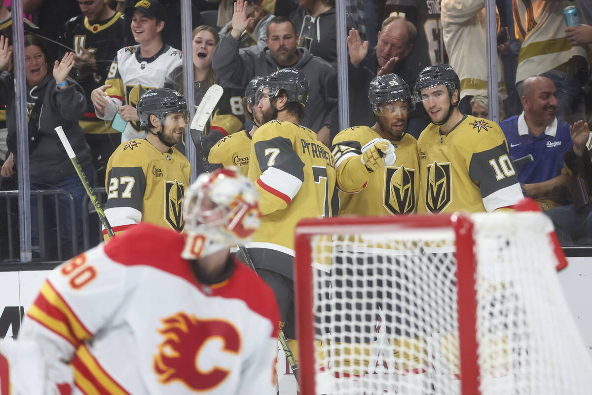 Golden Knights right wing Keegan Kolesar (55) and Golden Knights center Nicolas Roy (10) celebr ...