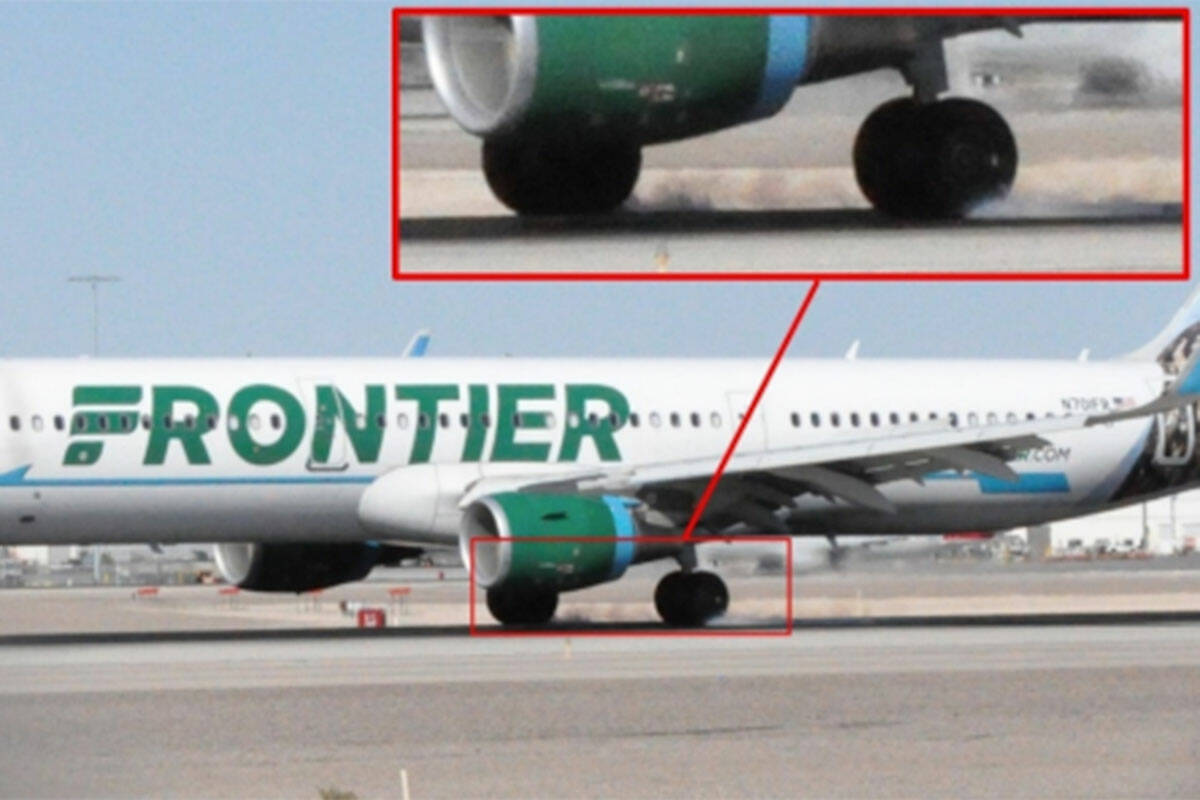 Photograph showing flames behind a Frontier Airlines plane's left main landing gear on Oct. 5, ...