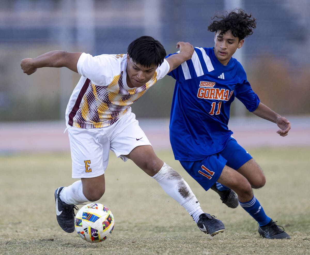 Eldorado midfielder Rogelio Berto, left, and Bishop Gorman midfielder Hector Miranda (11) compe ...