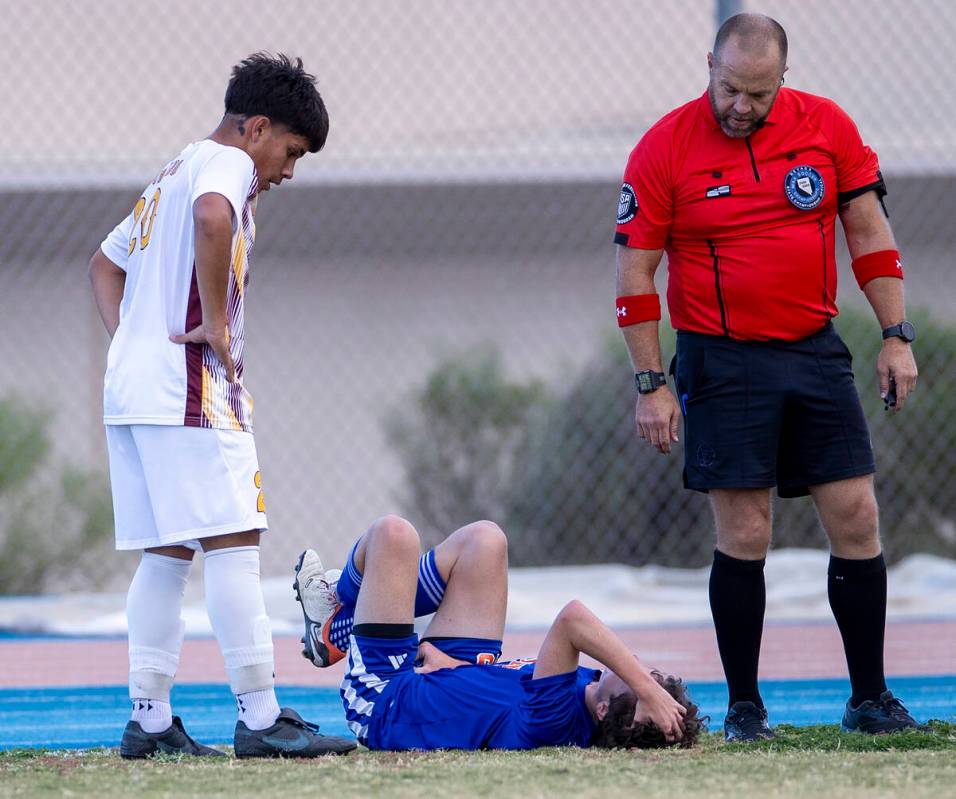 Bishop Gorman defender Maxim Mundson, center, reacts after taking a ball to the groin during th ...