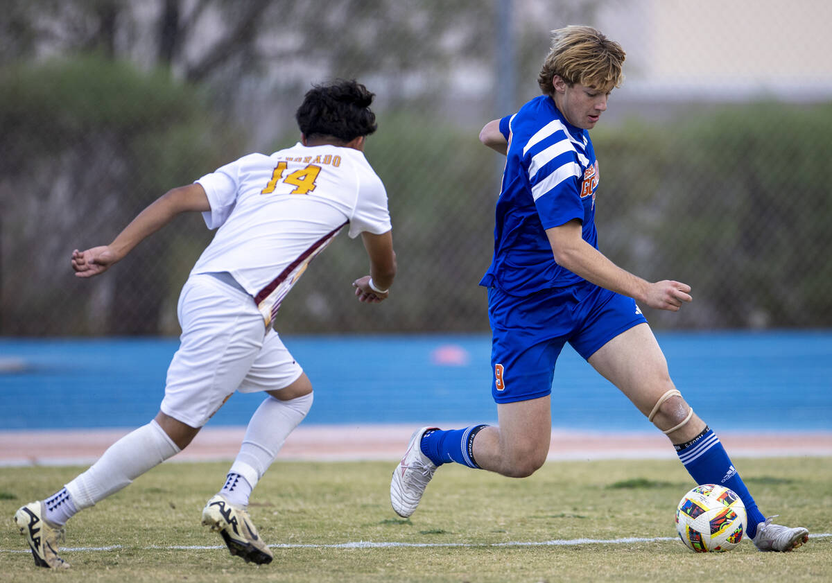 Bishop Gorman forward Chase Stewart (9) keeps the ball from Eldorado sophomore Angel Lopez (14) ...