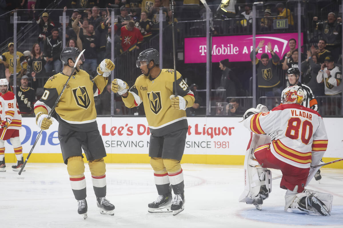 Golden Knights right wing Keegan Kolesar (55) celebrates his goal with Golden Knights center Ni ...