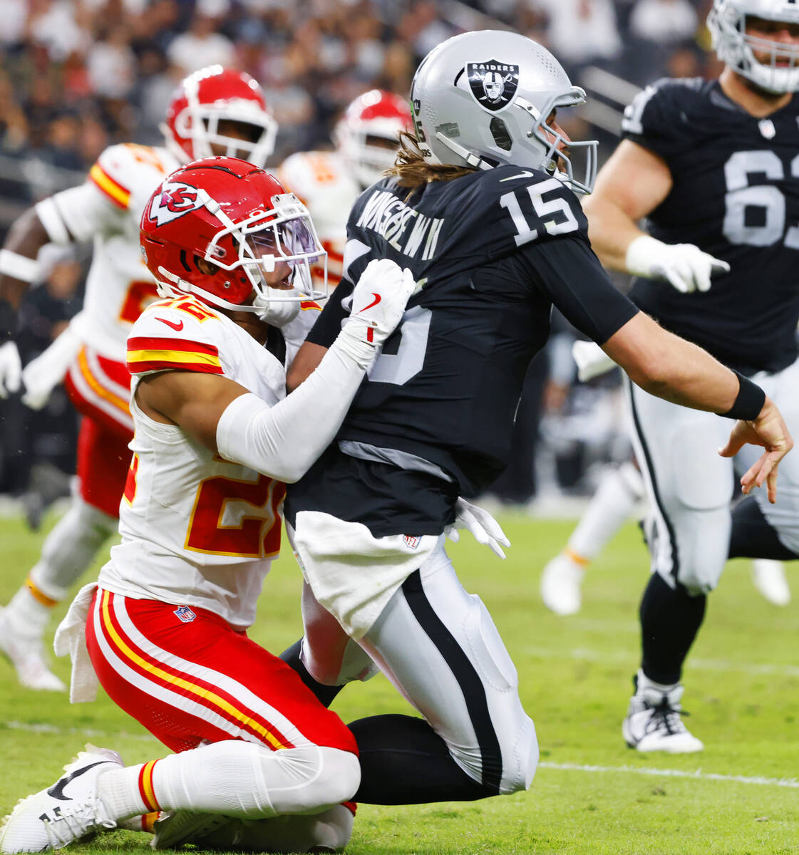 Raiders quarterback Gardner Minshew (15) is taken down by Kansas City Chiefs cornerback Trent M ...