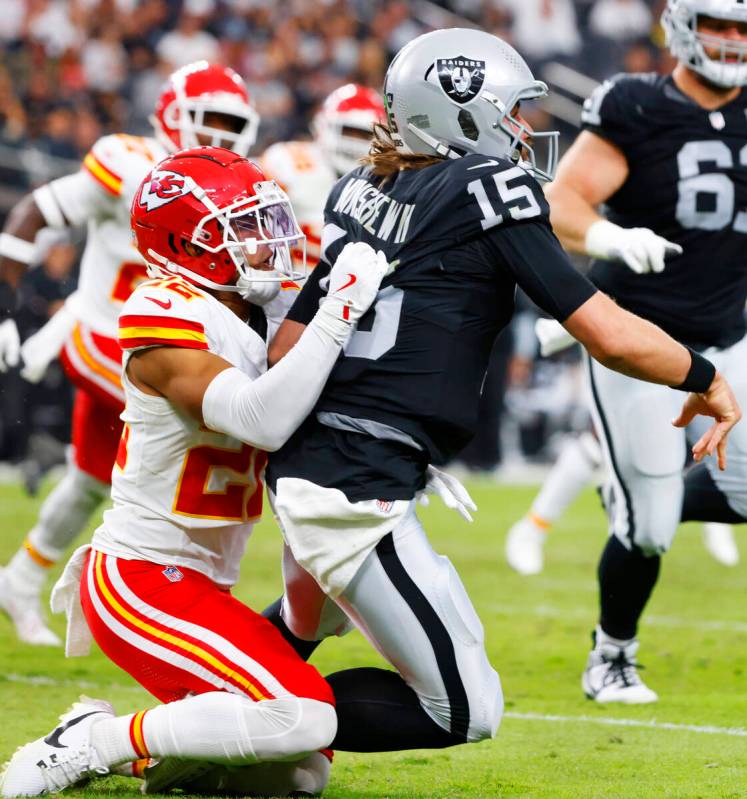 Raiders quarterback Gardner Minshew (15) is taken down by Kansas City Chiefs cornerback Trent M ...