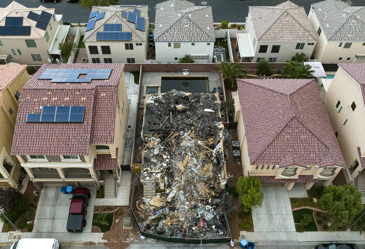 A now-demolished house that burned to the ground days before, killing two adults and two childr ...