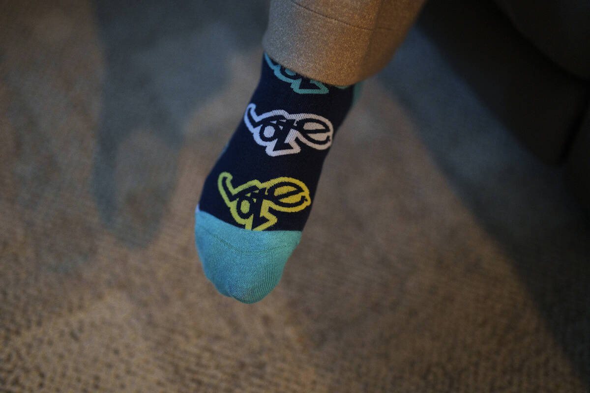 Cari-Ann Burgess, interim Registrar of Voters for Washoe County, Nev., wears socks with the wor ...