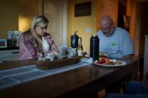 Cari-Ann Burgess, interim Registrar of Voters for Washoe County, Nev., left, prays with her hus ...