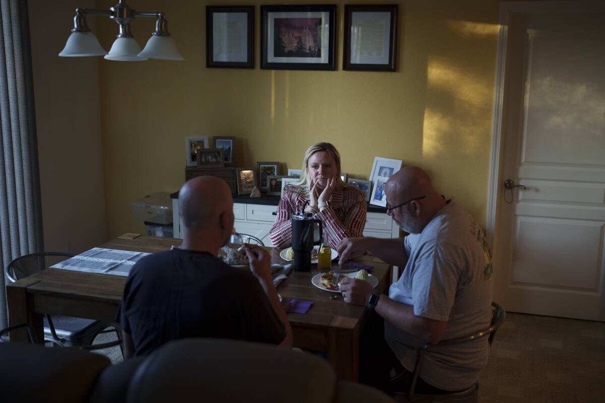 Cari-Ann Burgess, interim Registrar of Voters for Washoe County, Nev., center, eats dinner with ...