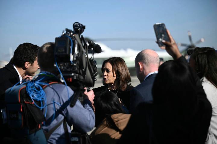 Democratic presidential nominee Vice President Kamala Harris talks to reporters before boarding ...