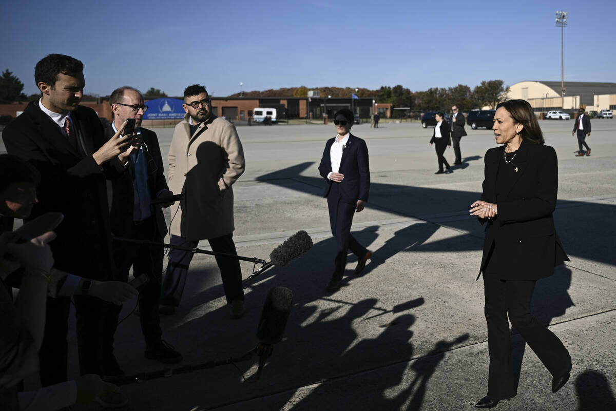 Democratic presidential nominee Vice President Kamala Harris talks to reporters before boarding ...