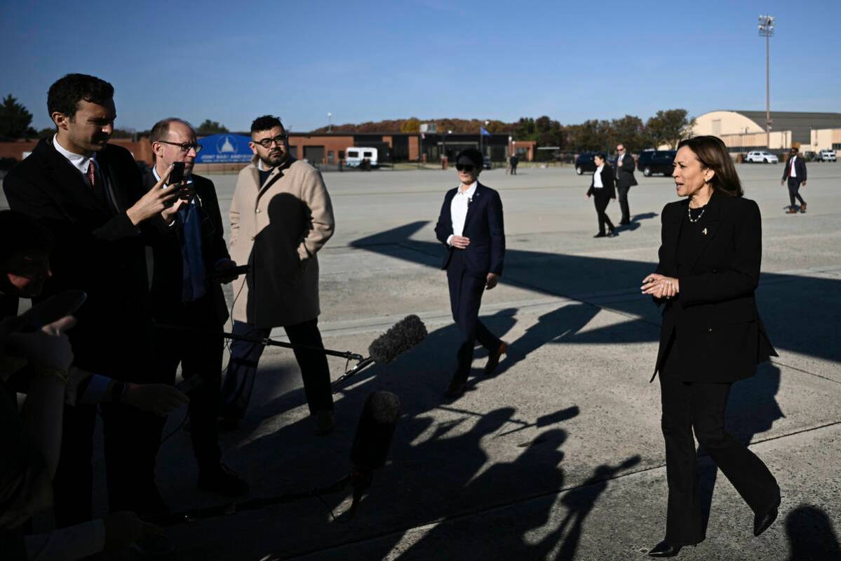 Democratic presidential nominee Vice President Kamala Harris talks to reporters before boarding ...