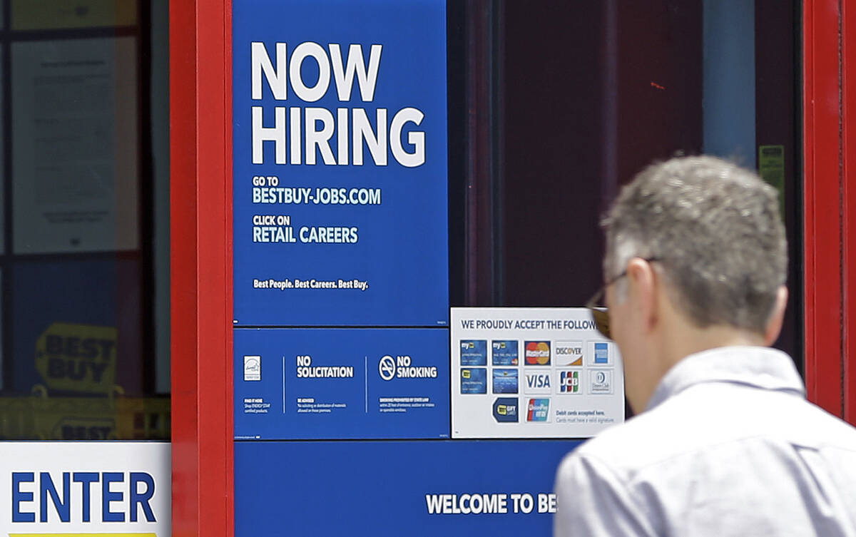 In this Monday, May 22, 2017, photo, a "Now Hiring" sign welcomes a customer entering ...