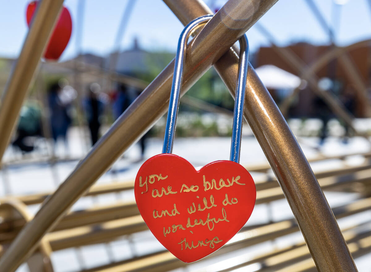 A Lock of Love is signed with a message and hung on a heart sculpture during St. Jude’s Ranch ...