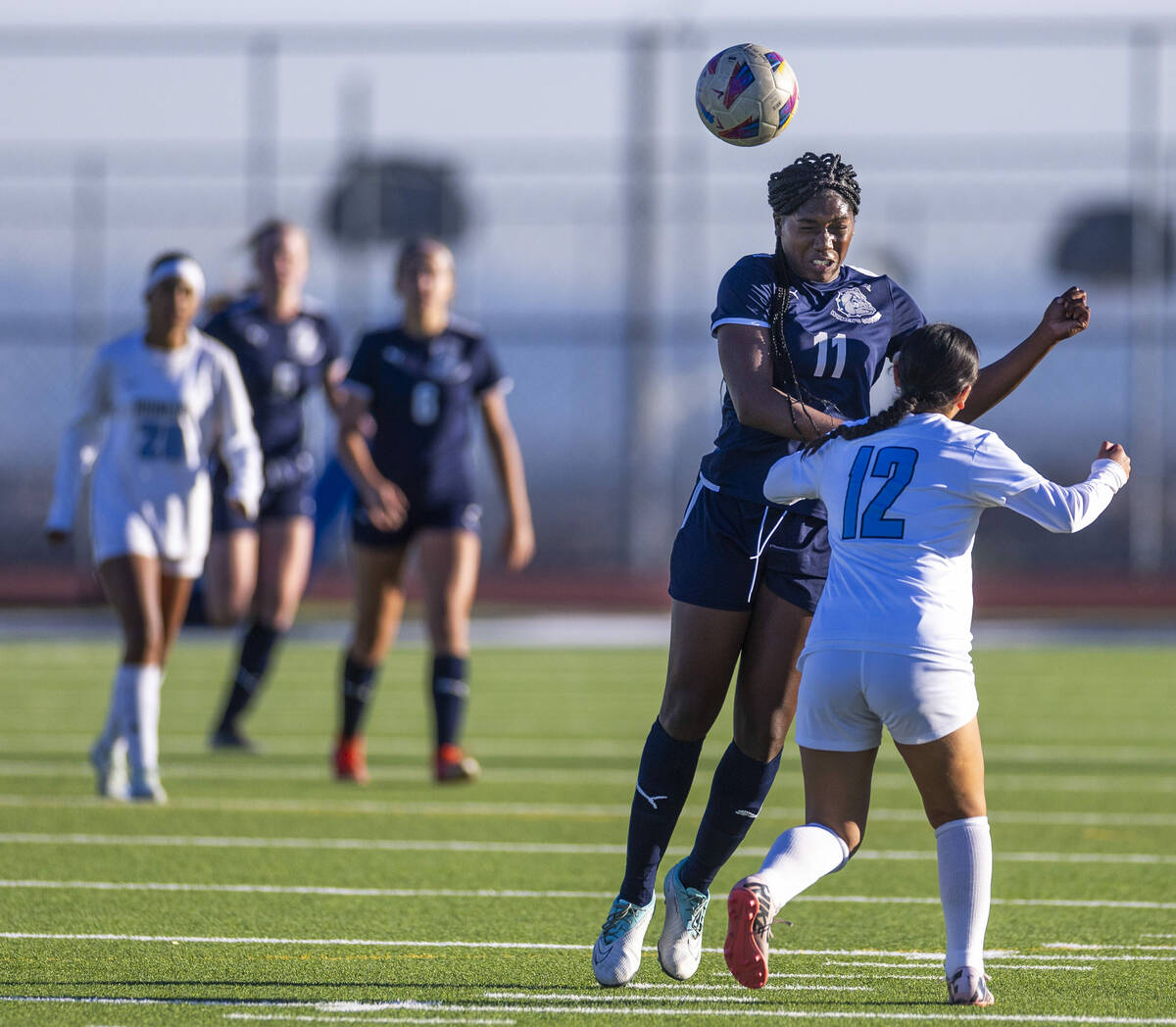 Centennial forward Natalie Penniston-John (11) heads the ball past Canyon Springs midfielder Ey ...