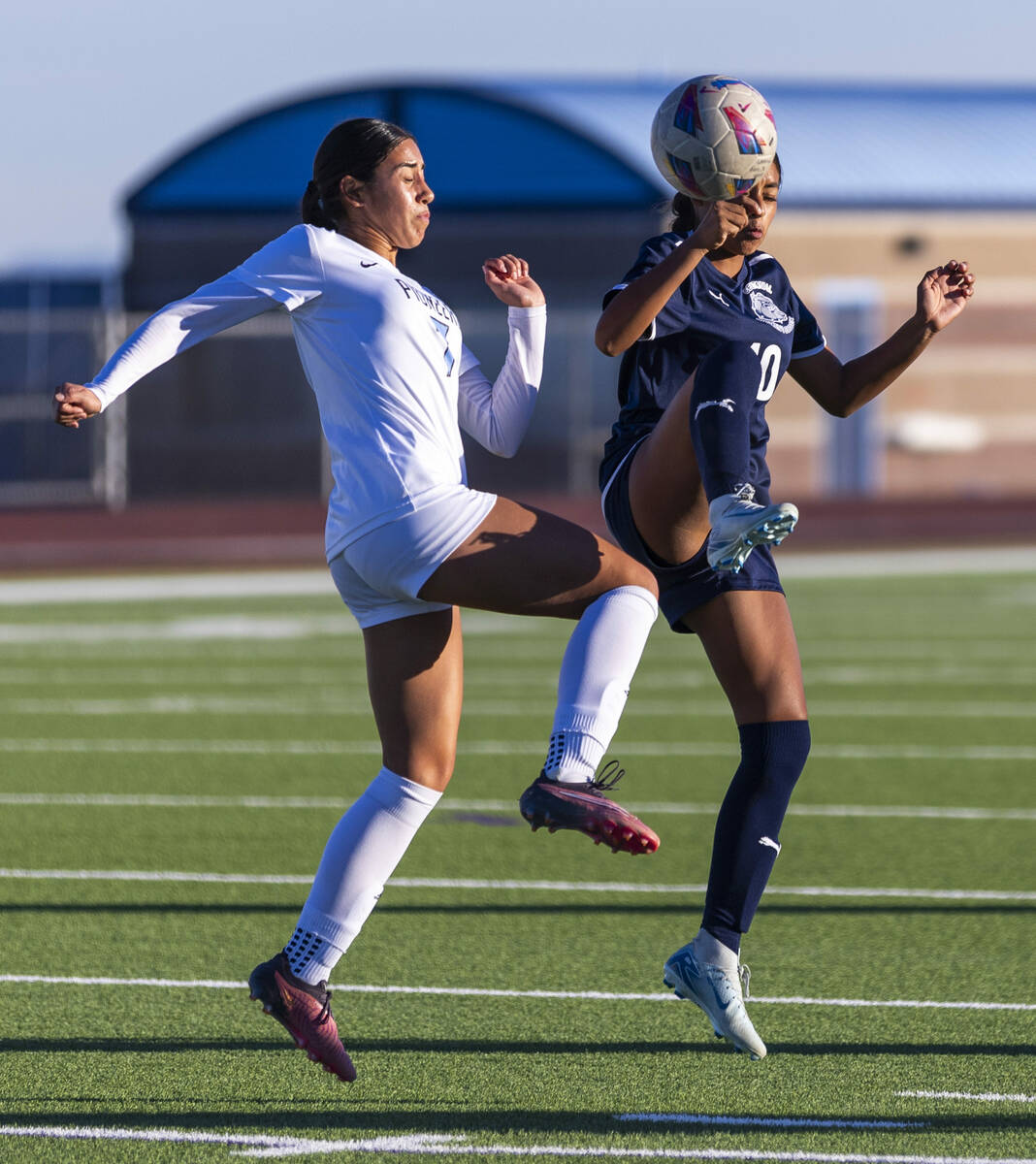 Centennial midfielder Alexandra Miranda (10) battles for the ball with Canyon Springs midfielde ...