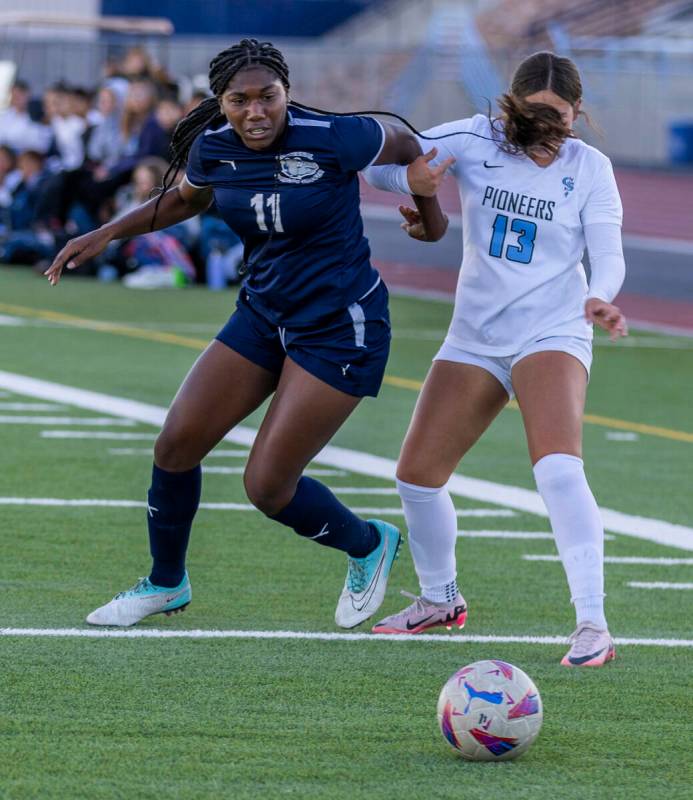 Centennial forward Natalie Penniston-John (11) battles for the ball with Canyon Springs defende ...