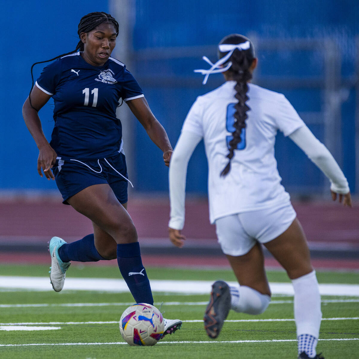 Centennial forward Natalie Penniston-John (11) dribbles up the field as Canyon Springs defender ...