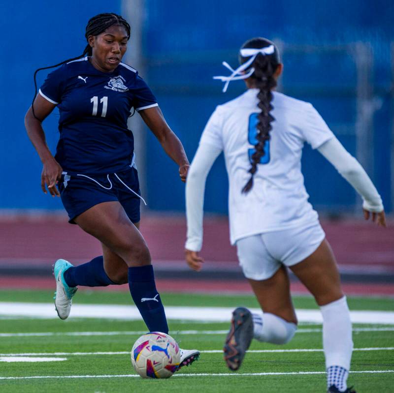 Centennial forward Natalie Penniston-John (11) dribbles up the field as Canyon Springs defender ...