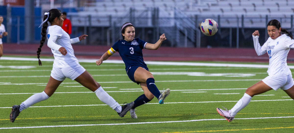 Canyon Springs defender Carolina Godoy (9) arrives late as Centennial forward Natalie Sligar (3 ...