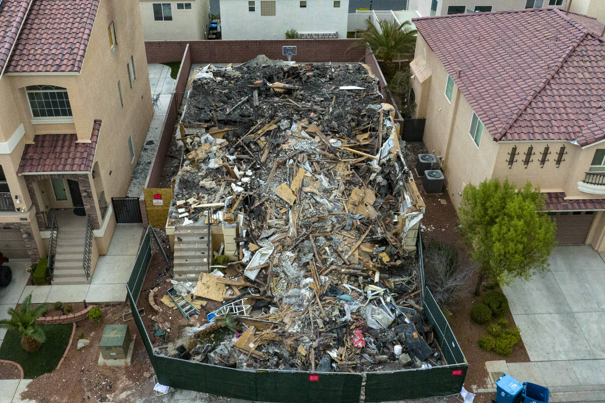 A now-demolished house that burned to the ground days before, killing two adults and two childr ...