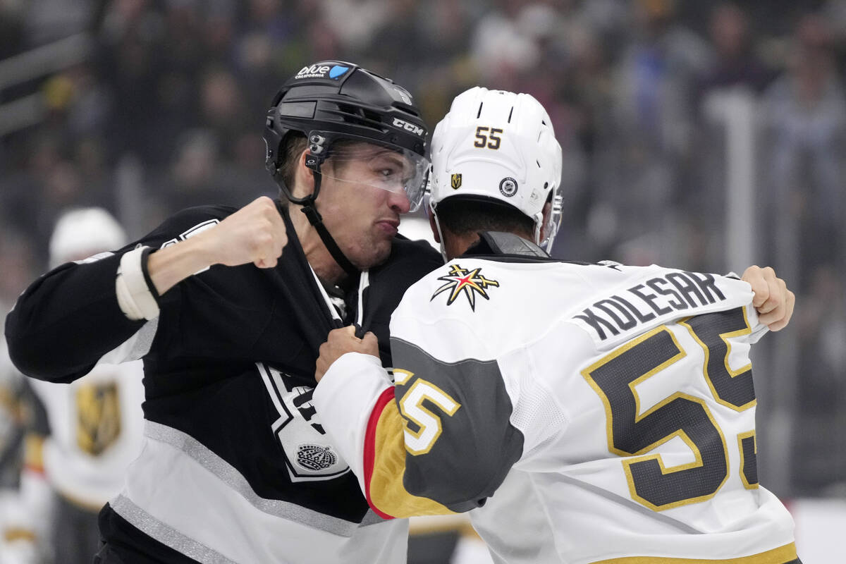 Los Angeles Kings' Andreas Englund, left, and Vegas Golden Knights' Keegan Kolesar fight during ...