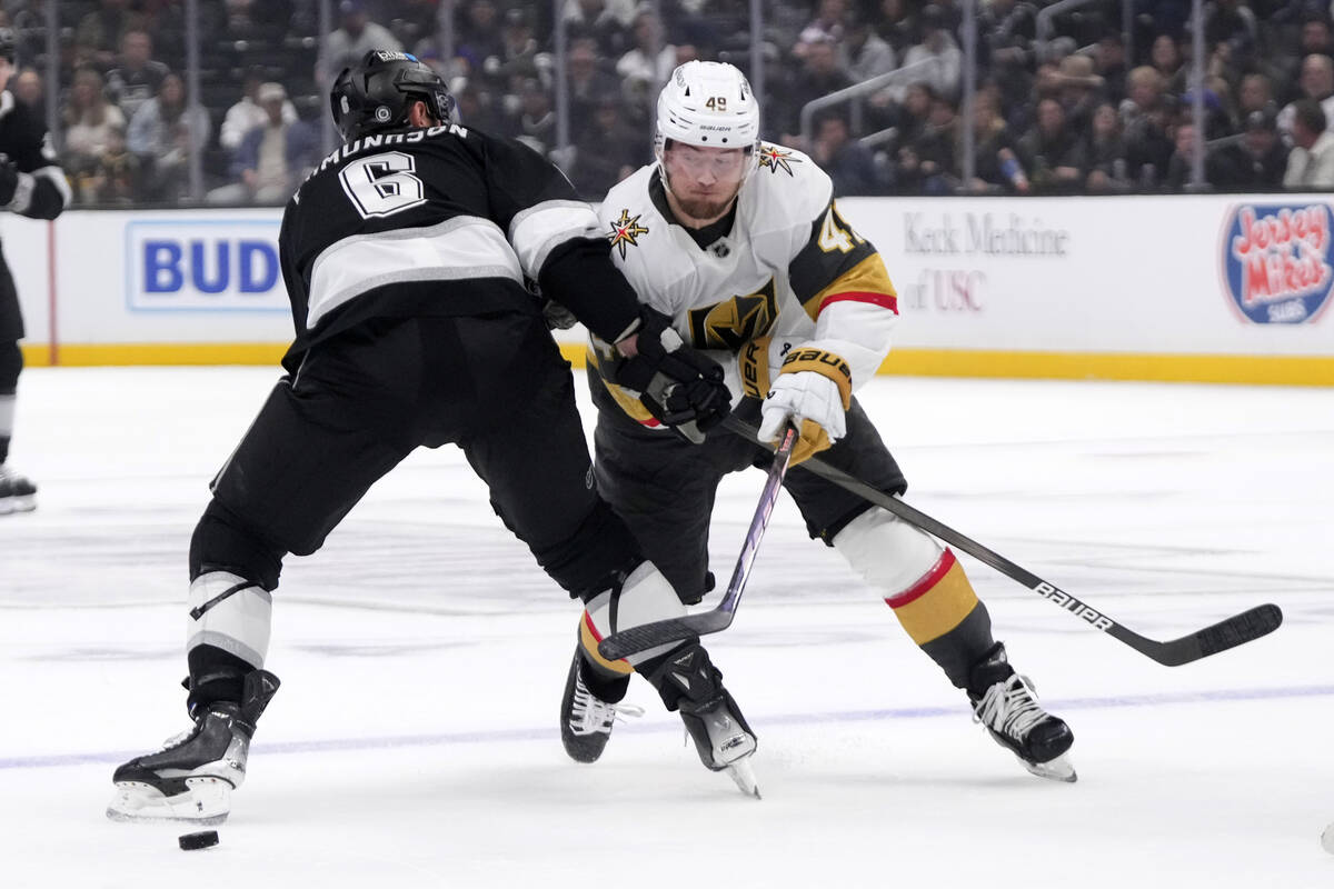 Los Angeles Kings' Joel Edmundson, left, battles with Vegas Golden Knights' Ivan Barbashev duri ...