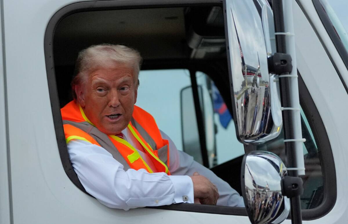 Donald Trump talks to reporters as he sits in a garbage truck Wednesday, Oct. 30, 2024, in Gree ...