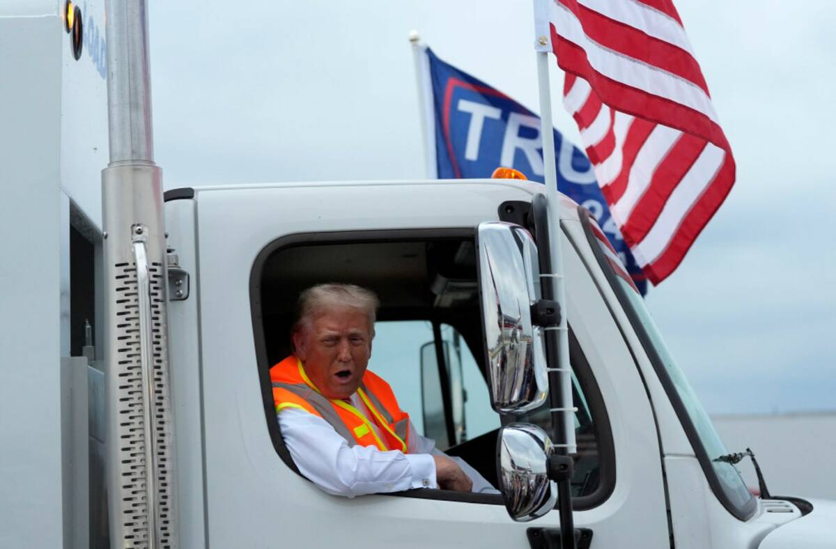 Donald Trump talks to reporters as he sits in a garbage truck Wednesday, Oct. 30, 2024, in Gree ...