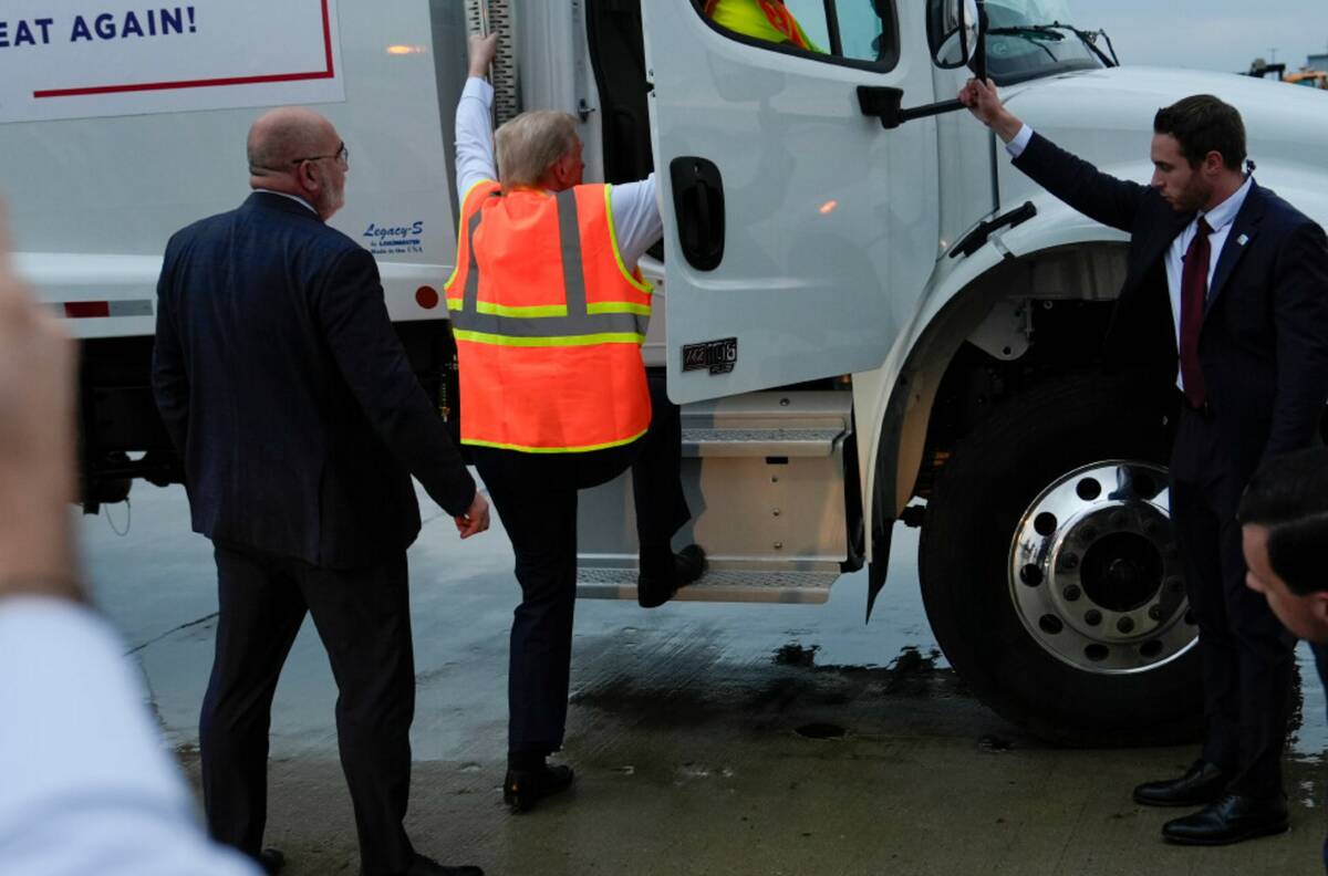 Donald Trump climbs into a garbage truck Wednesday, Oct. 30, 2024, as he arrives in Green Bay, ...