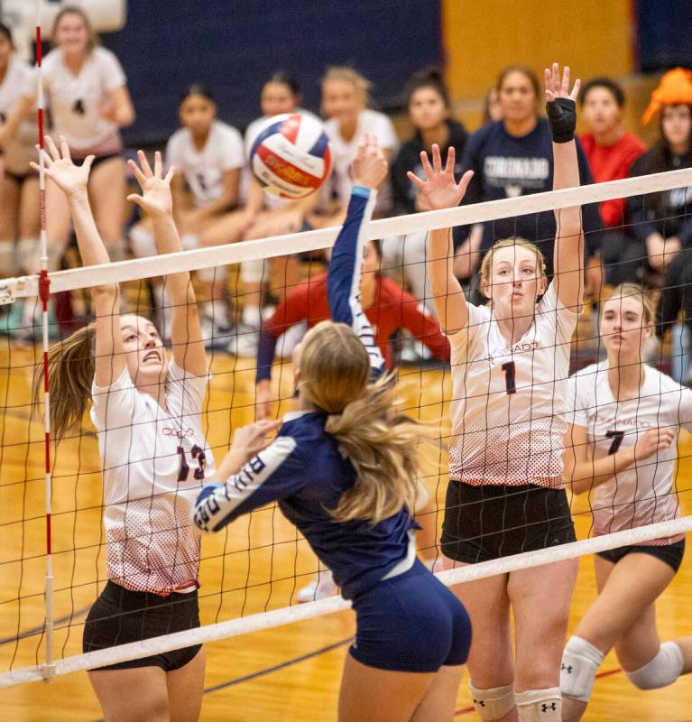 Coronado senior Jeya Dupris (13) and junior Hannah Wayment (1) attempt to block a spike by Cent ...