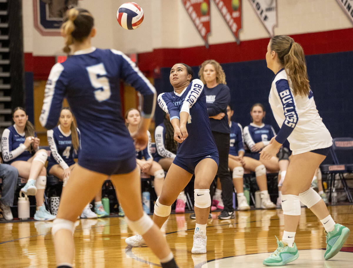 Centennial sophomore Audrianne Bernard, center, receives the ball during the 5A girls volleybal ...