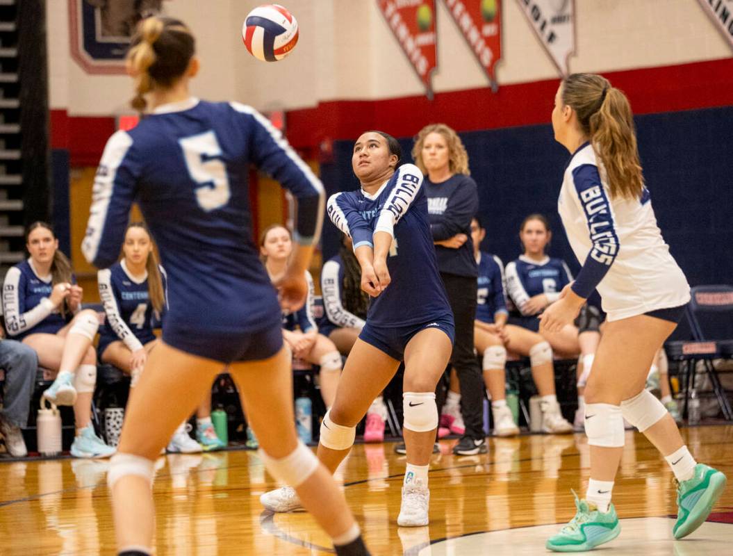 Centennial sophomore Audrianne Bernard, center, receives the ball during the 5A girls volleybal ...