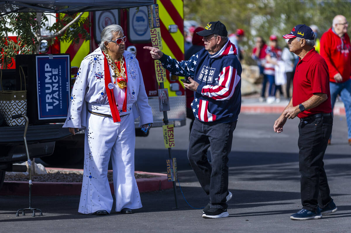 Supporters talk outside in the parking lot before former President Donald Trump arrives for a r ...