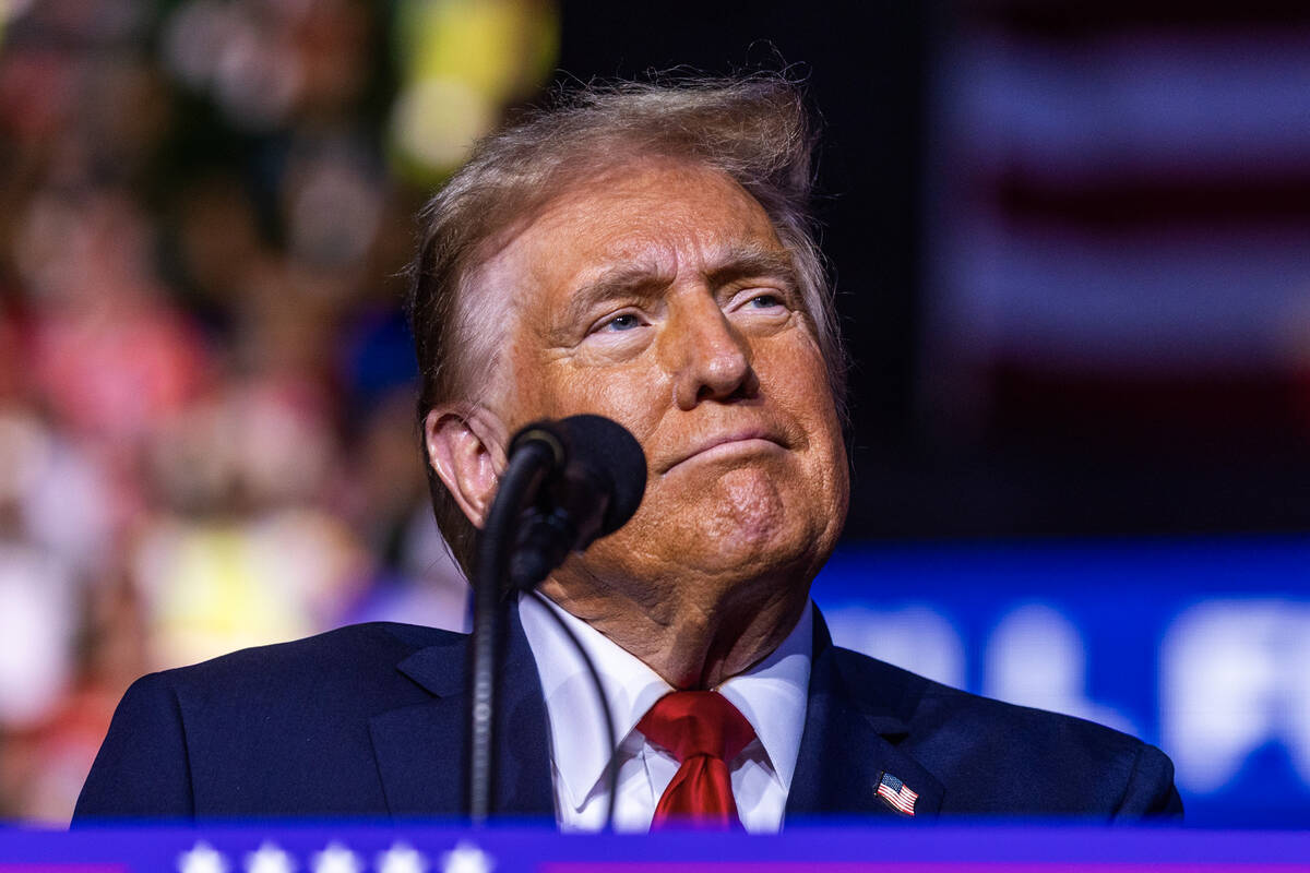 Former President Donald Trump listens to a video as he speaks during a rally at the Lee's Famil ...