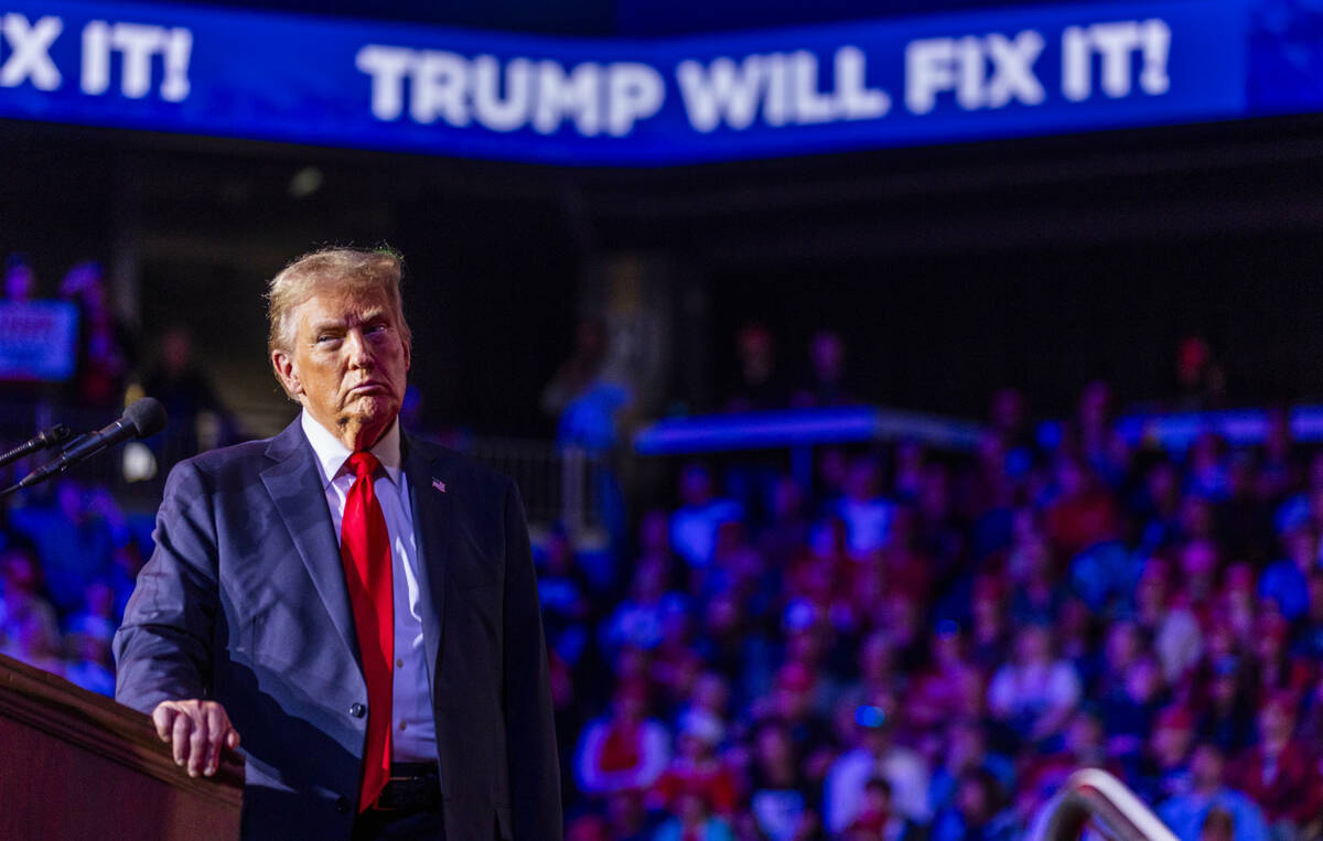 Former President Donald Trump listens to a video presentation as he speaks during a rally at th ...