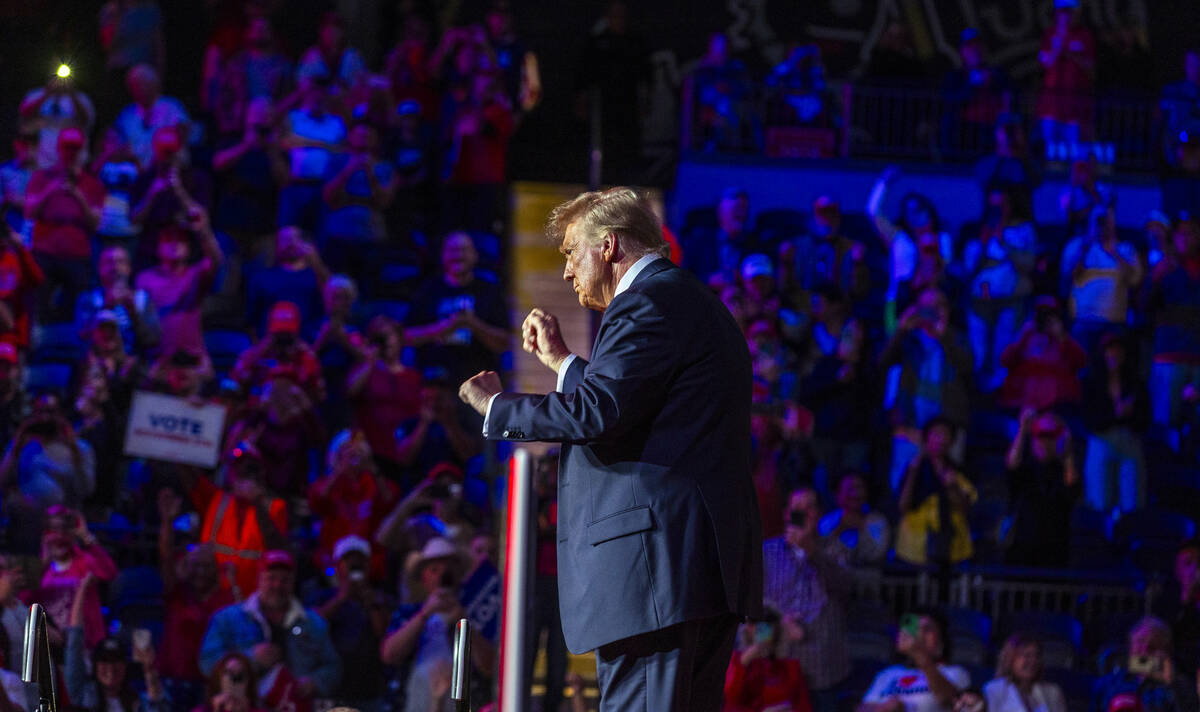 Former President Donald Trump dances with supporters after speaking during a rally at the Lee's ...