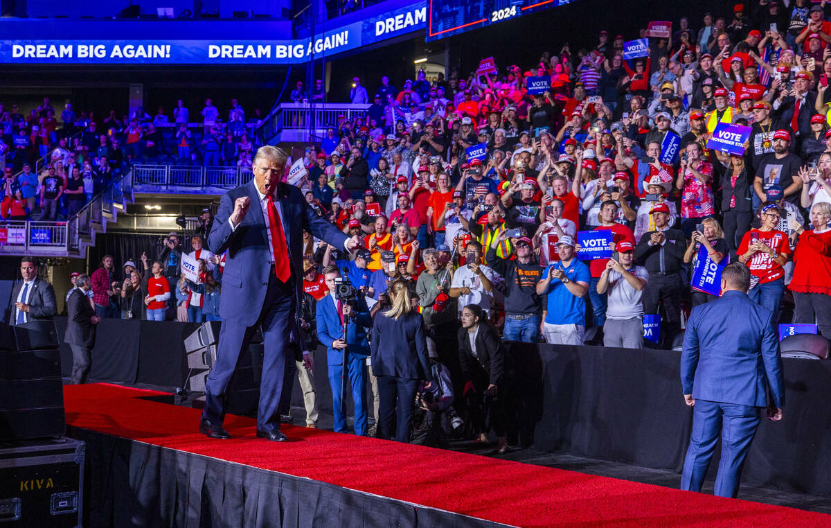 Former President Donald Trump dances with supporters after speaking during a rally at the Lee's ...