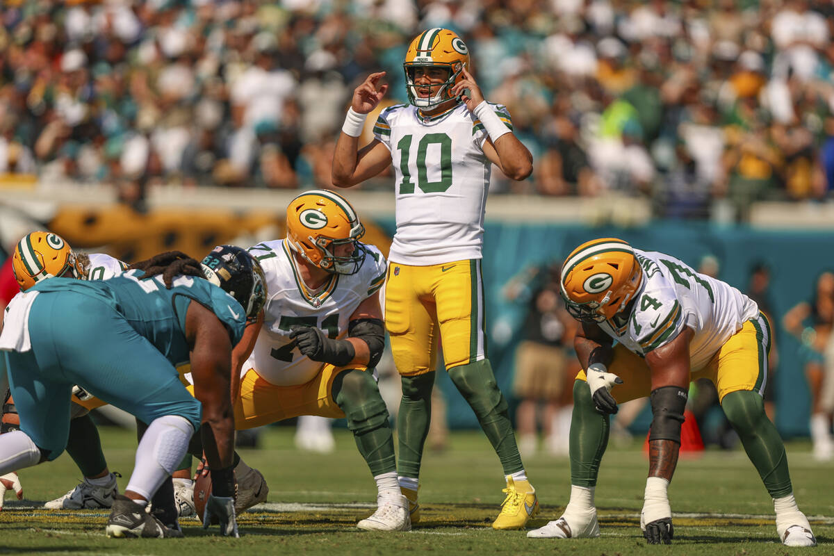 Green Bay Packers quarterback Jordan Love (10) signals during an NFL football game against the ...