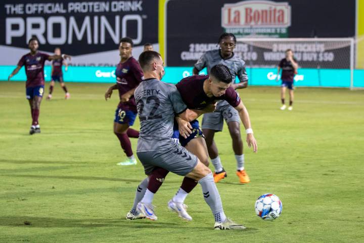 Las Vegas Lights FC defender Joe Hafferty (22) fends off Detroit City FC forward Jeciel Cede&#x ...