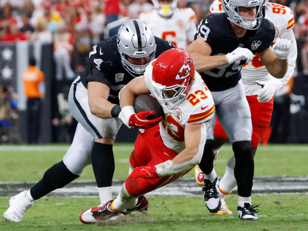 Kansas City Chiefs linebacker Drue Tranquill (23) is taken down by Raiders offensive tackle Kol ...