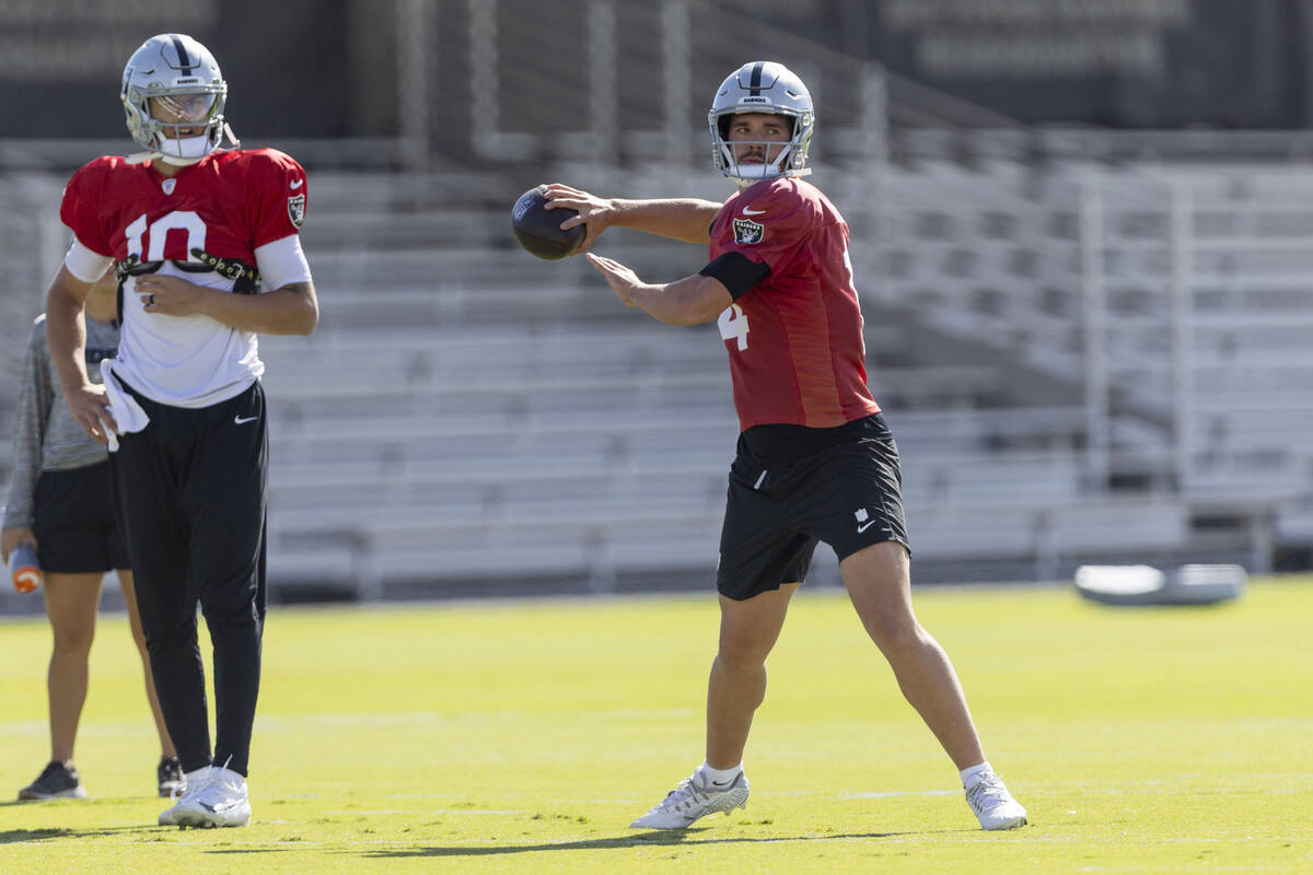 Raiders quarterback Desmond Ridder (10) looks on as quarterback Carter Bradley (14) throws the ...