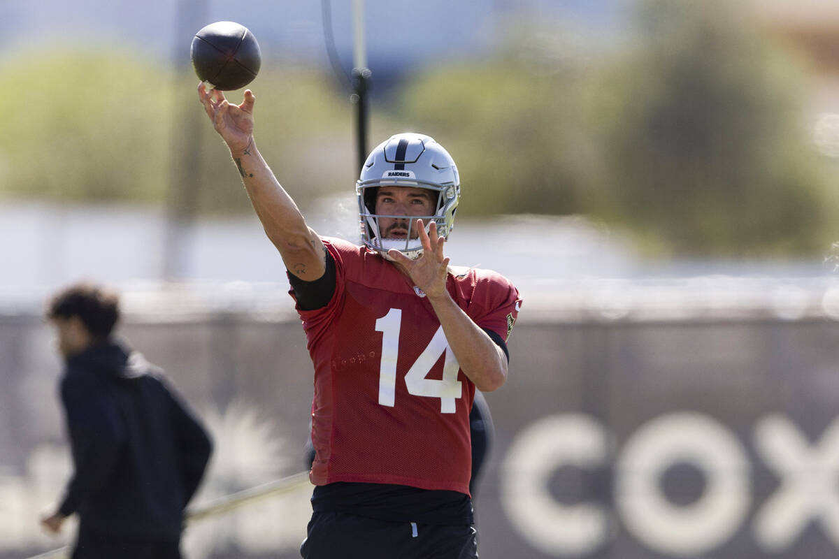 Raiders quarterback Carter Bradley (14) throws the football during team practice at the Intermo ...