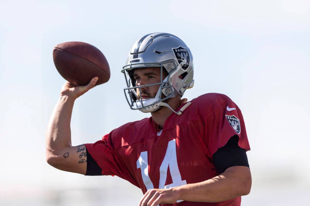 Raiders quarterback Carter Bradley (14) throws the football during team practice at the Intermo ...