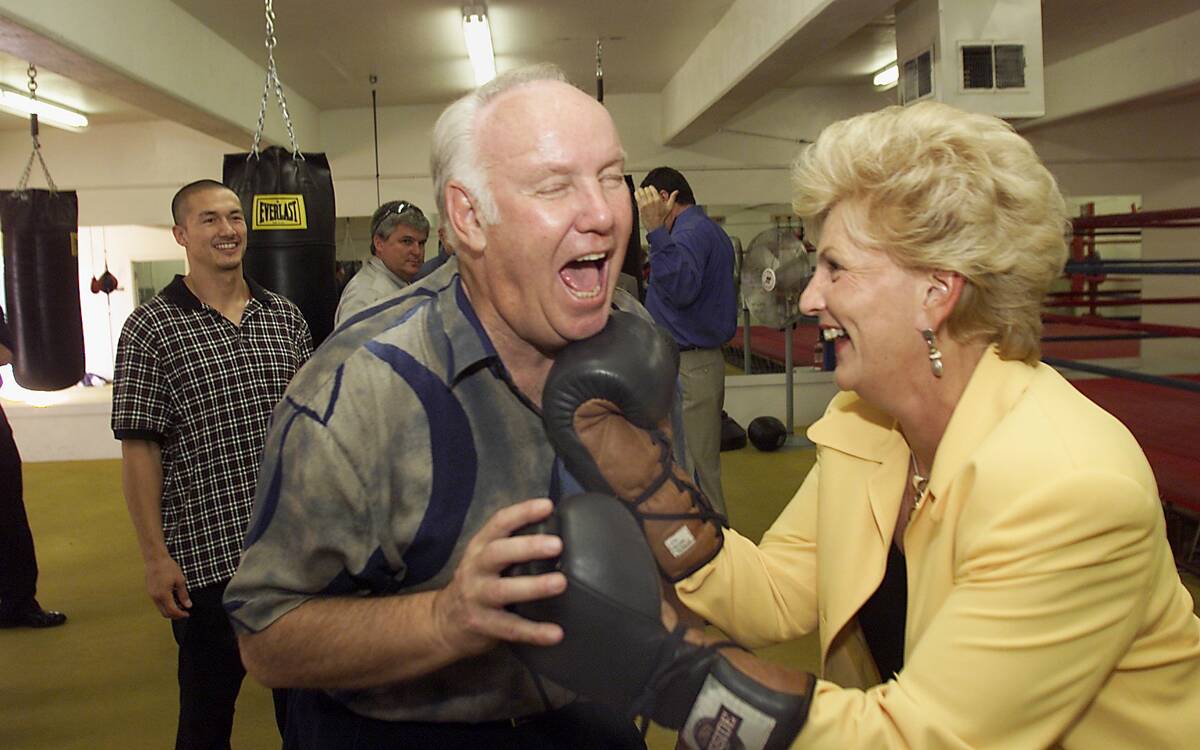 UNLV President Carol Harter punches UNLV Football Coach and Athletic Director John Robinson at ...