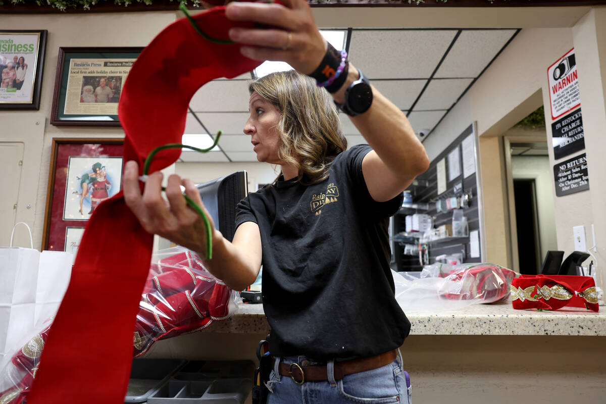 Co-owner Kate Jones shows a Christmas decoration display option for a customer at Ralph Jones D ...