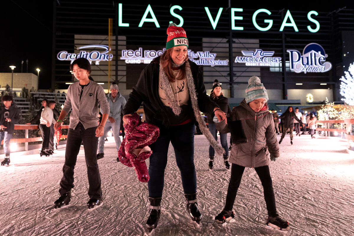 Ice skaters enjoy the Enchant Christmas light show at Las Vegas Ballpark. (Ellen Schmidt/Las Ve ...